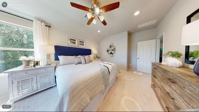 carpeted bedroom featuring ceiling fan and vaulted ceiling