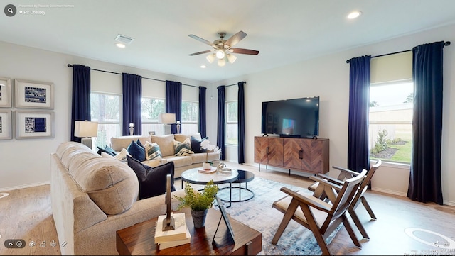 living room featuring light wood-type flooring and ceiling fan