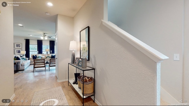 hallway with light hardwood / wood-style floors