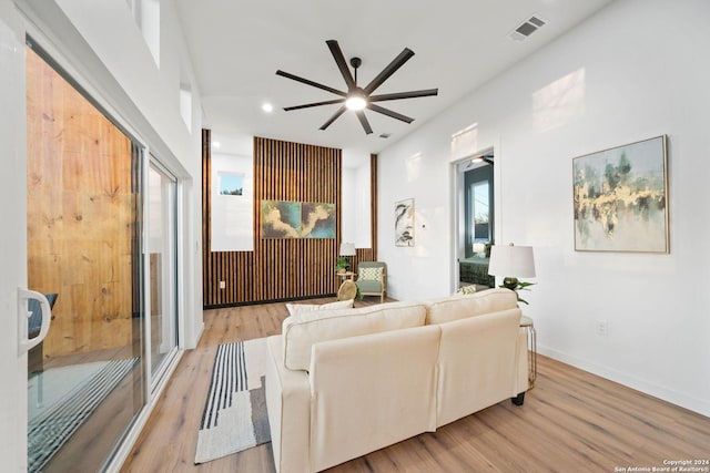 living room with ceiling fan and wood-type flooring