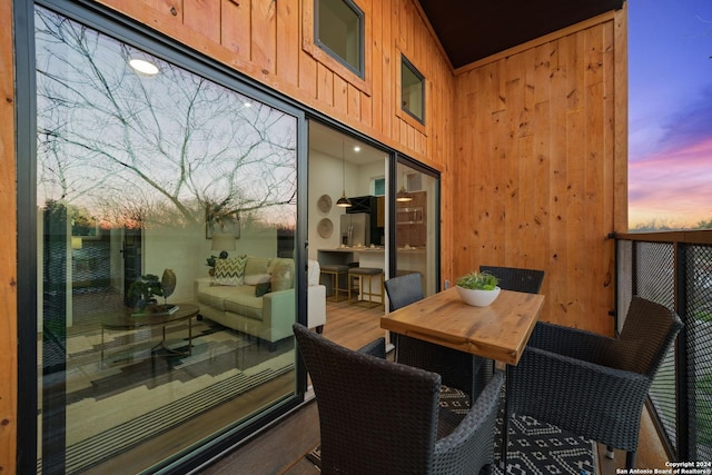 balcony at dusk featuring an outdoor living space