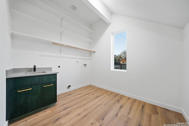 washroom with electric dryer hookup, sink, gas dryer hookup, light hardwood / wood-style floors, and washer hookup