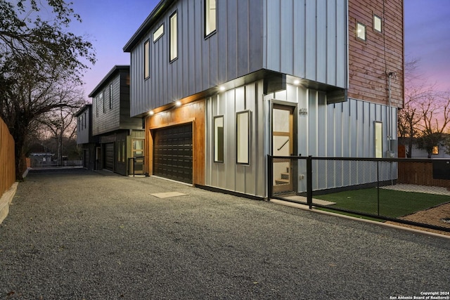 property exterior at dusk featuring a garage