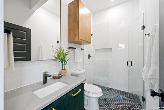 bathroom featuring vanity, toilet, and a shower with door