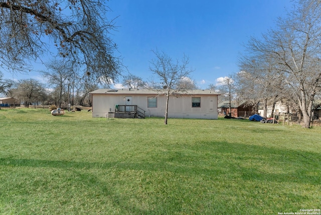 rear view of house featuring a lawn