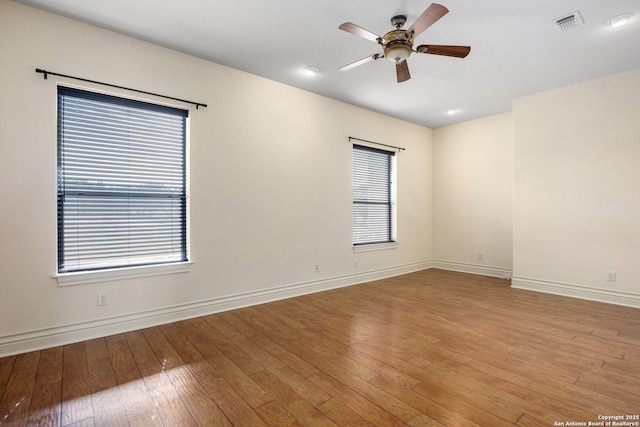 unfurnished room with ceiling fan, light hardwood / wood-style flooring, and plenty of natural light