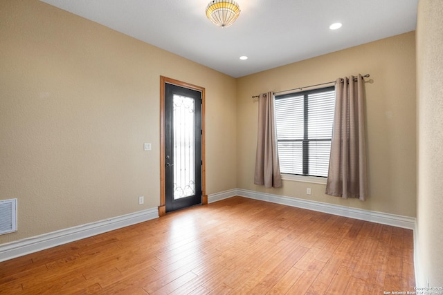 unfurnished room with plenty of natural light and light wood-type flooring