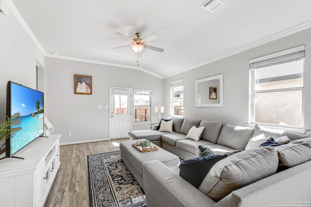 living room with light wood-type flooring, vaulted ceiling, and crown molding