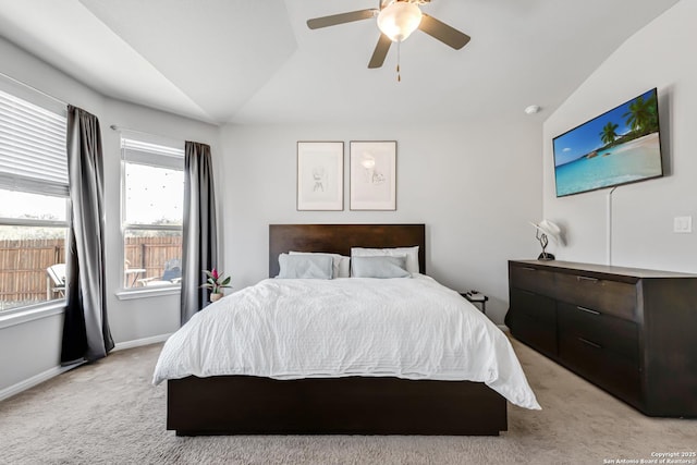 carpeted bedroom featuring ceiling fan and vaulted ceiling