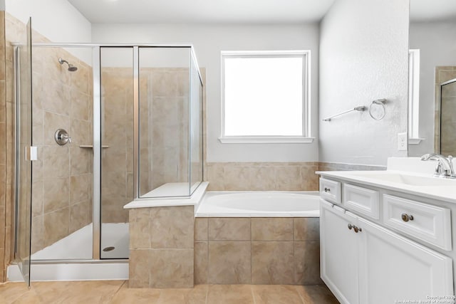 bathroom with independent shower and bath, tile patterned flooring, and vanity