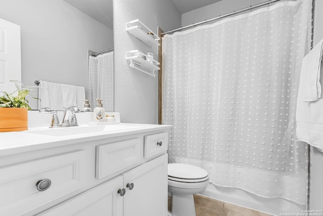 bathroom with tile patterned floors, vanity, and toilet