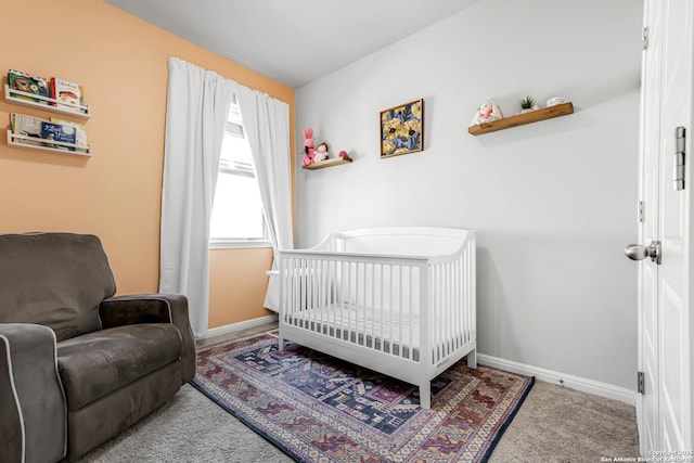 carpeted bedroom with a nursery area