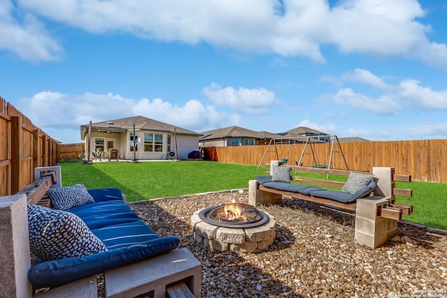 view of yard with a fire pit, a patio area, and a playground