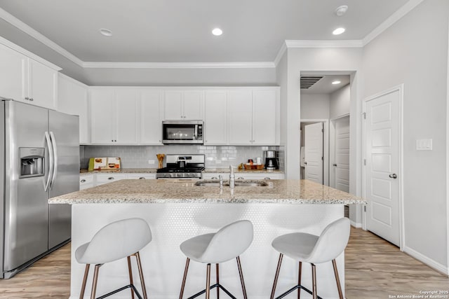 kitchen with sink, a center island with sink, white cabinets, and appliances with stainless steel finishes