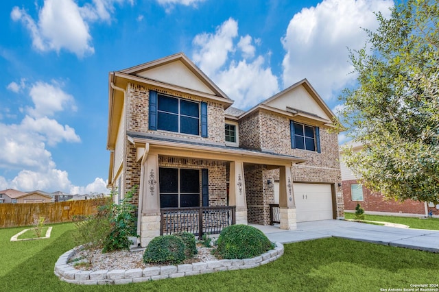 front of property featuring a garage, covered porch, and a front yard