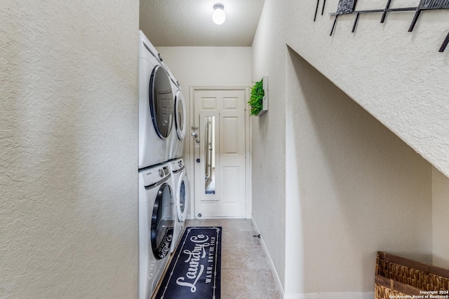 laundry room featuring stacked washer and clothes dryer and light tile patterned floors