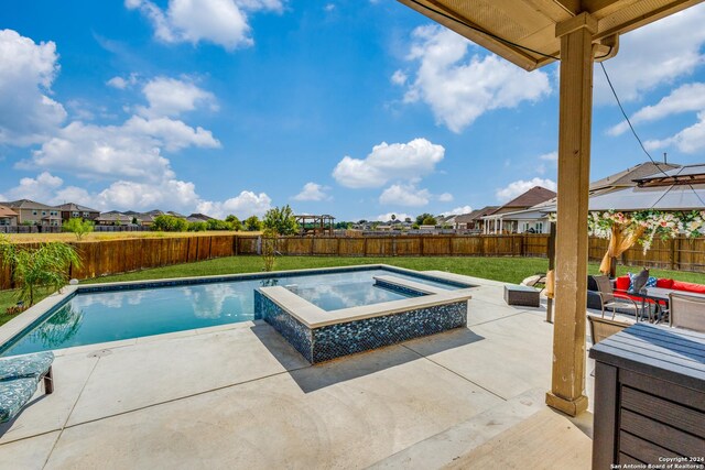 view of swimming pool with an in ground hot tub, an outdoor living space, a lawn, and a patio