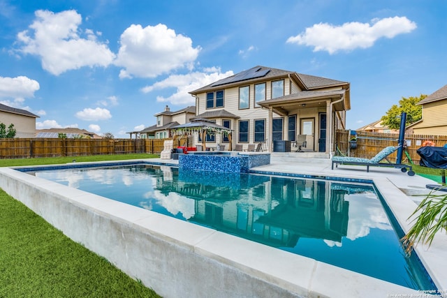 view of swimming pool featuring an in ground hot tub, a patio, and a gazebo