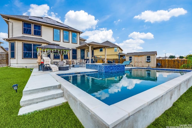 view of swimming pool featuring a lawn, a patio, a storage shed, outdoor lounge area, and a gazebo