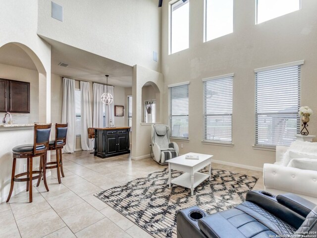 tiled living room featuring a towering ceiling