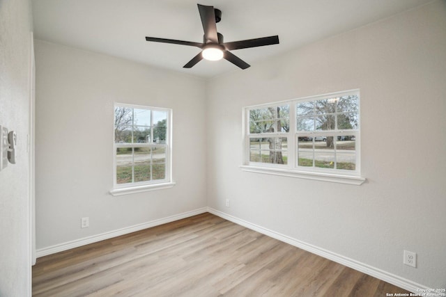 spare room featuring light wood-type flooring and ceiling fan