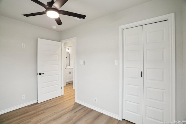 unfurnished bedroom with ceiling fan, a closet, and light hardwood / wood-style flooring