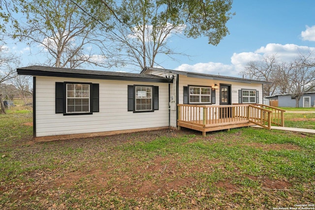 exterior space featuring a front lawn and a deck