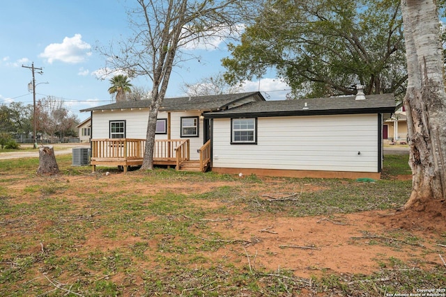 rear view of house featuring a yard, cooling unit, and a deck