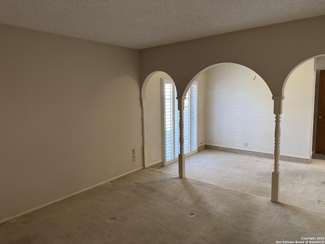 carpeted spare room featuring a textured ceiling