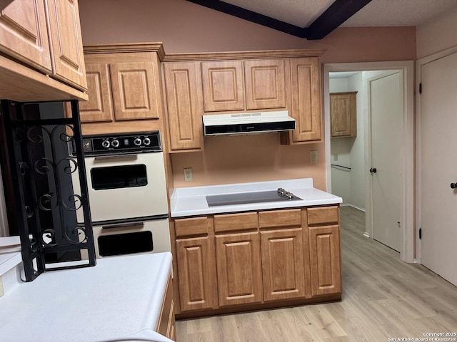 kitchen featuring lofted ceiling with beams, double oven, black electric cooktop, and light wood-type flooring