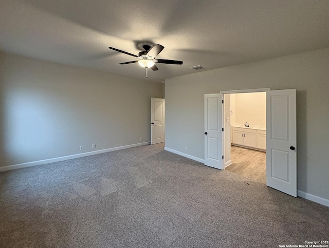 unfurnished bedroom featuring light colored carpet and ceiling fan