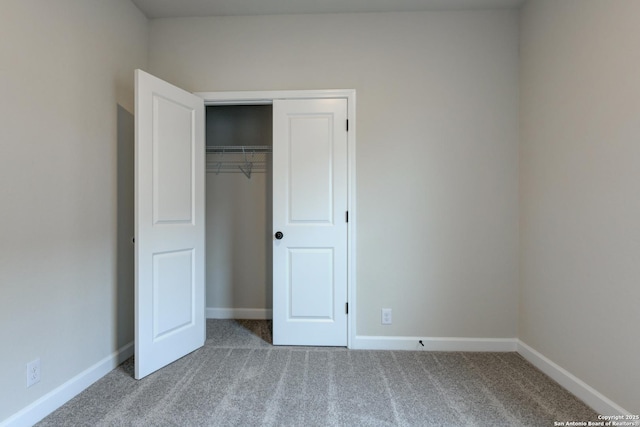 unfurnished bedroom featuring carpet flooring and a closet