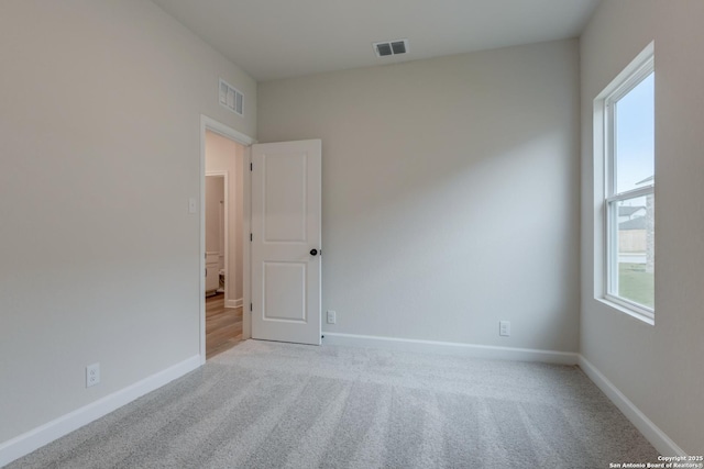 unfurnished room with light carpet