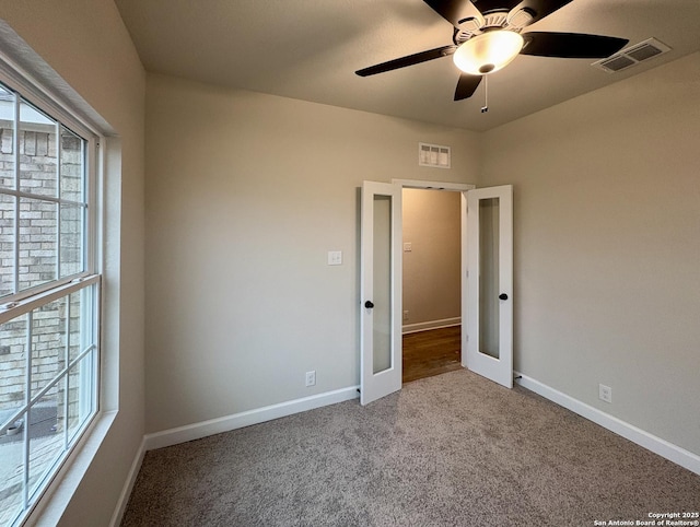 unfurnished bedroom with french doors, ceiling fan, and carpet flooring