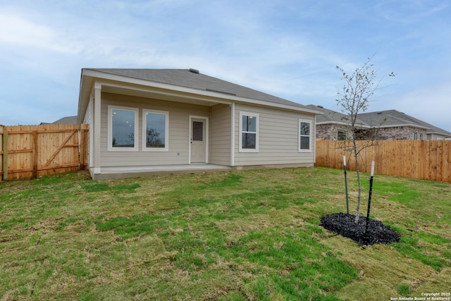 back of property featuring a patio area and a lawn