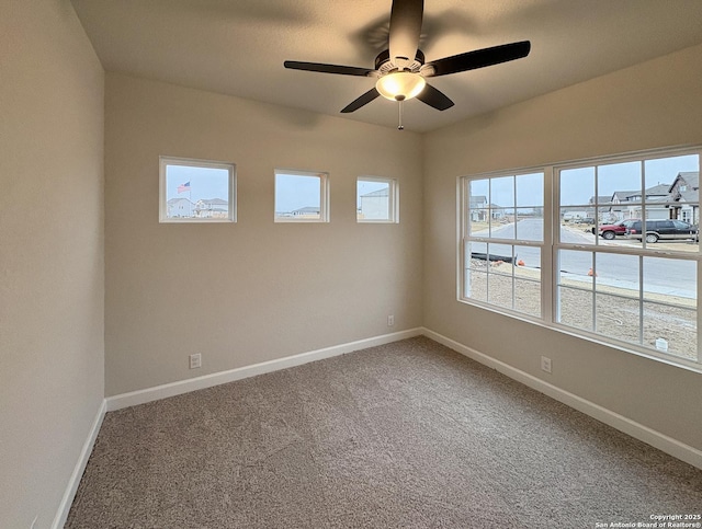 carpeted empty room featuring ceiling fan