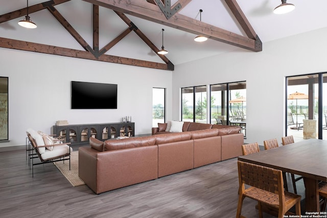 living room featuring beamed ceiling, hardwood / wood-style floors, and high vaulted ceiling