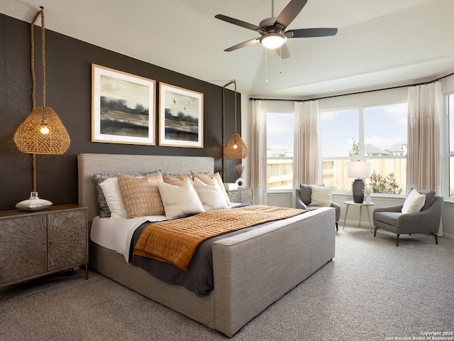 bedroom with ceiling fan, carpet flooring, and lofted ceiling