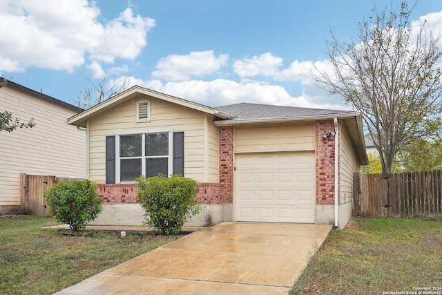 single story home featuring a garage and a front lawn