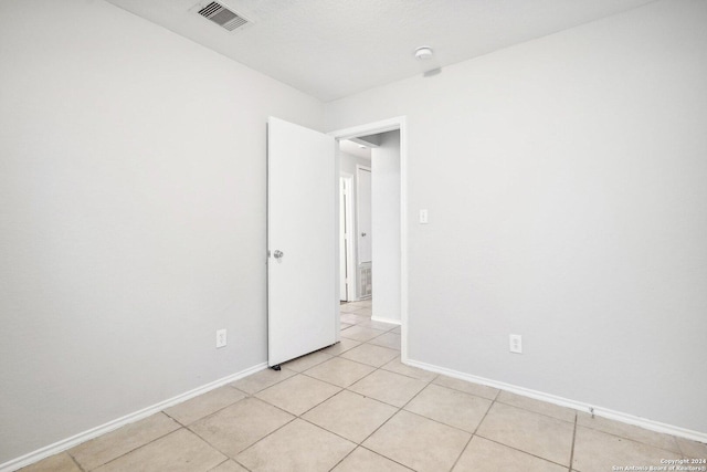 spare room with light tile patterned floors