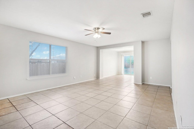 tiled empty room featuring ceiling fan