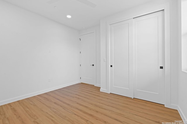 unfurnished bedroom featuring light hardwood / wood-style floors and a closet