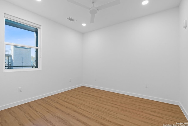 empty room with ceiling fan and hardwood / wood-style floors