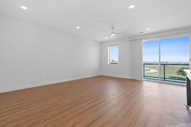 unfurnished room with ceiling fan and light hardwood / wood-style flooring