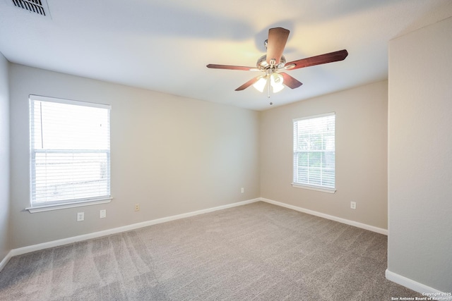 unfurnished room featuring ceiling fan and carpet