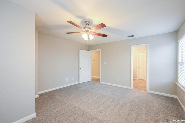 carpeted spare room featuring ceiling fan