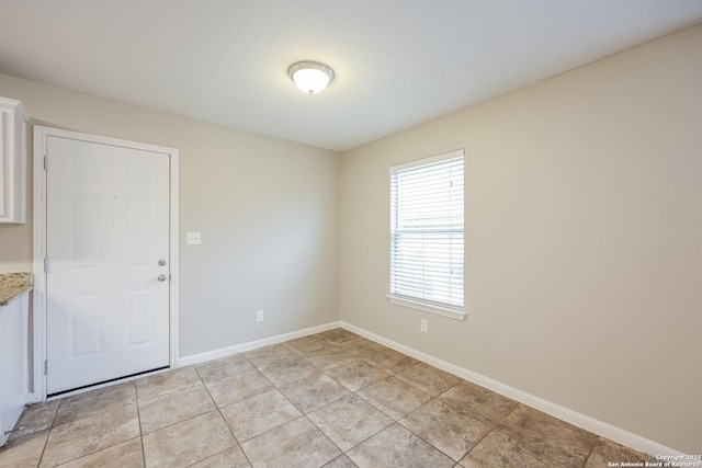 unfurnished room featuring light tile patterned flooring