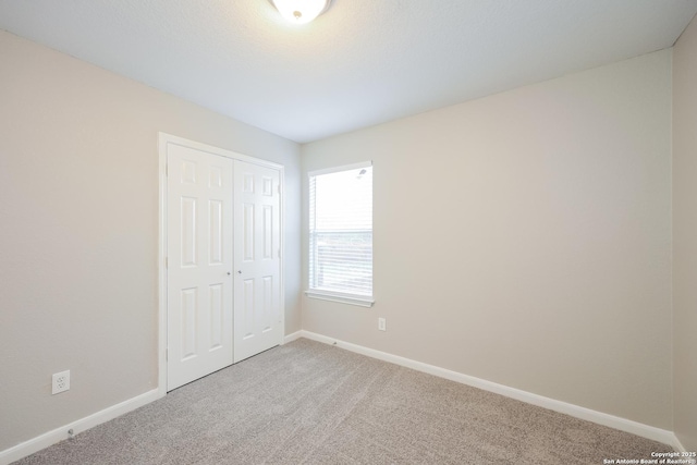 unfurnished bedroom with carpet floors and a closet