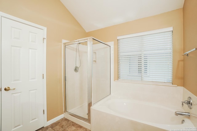 bathroom featuring plus walk in shower and lofted ceiling