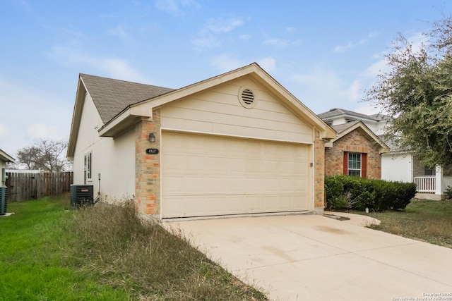 ranch-style home featuring a garage and cooling unit